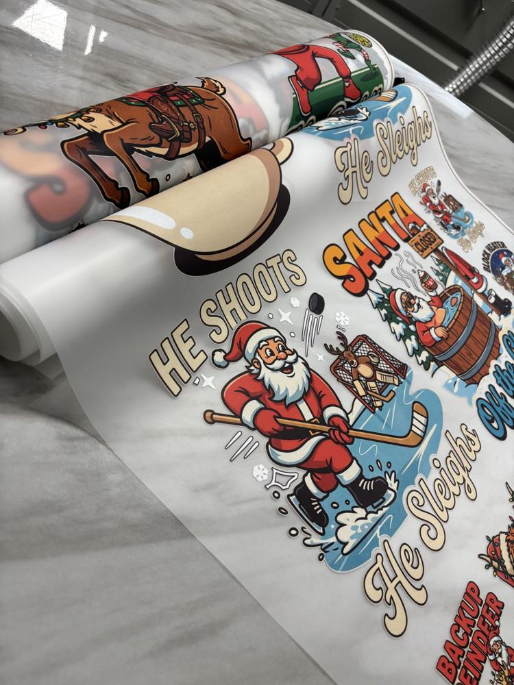 Real photo: printed He Shoots, He Sleighs hockey Santa DTF transfer on the roll